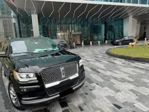 Our Luxury Lincoln Navigator in front of a sky scraper