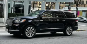 Luxury Black Cars on the Road in Front of Skyscrapers