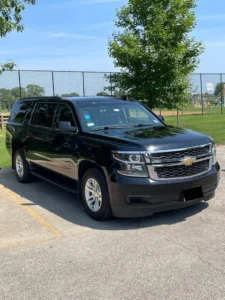 Our Luxury Chevy Suburban stands outside a garden