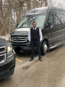 Our Chauffeur Stands in front of luxury Mercedes Sprinter Van