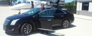 Chauffeur with Black Sedan at Private Airport